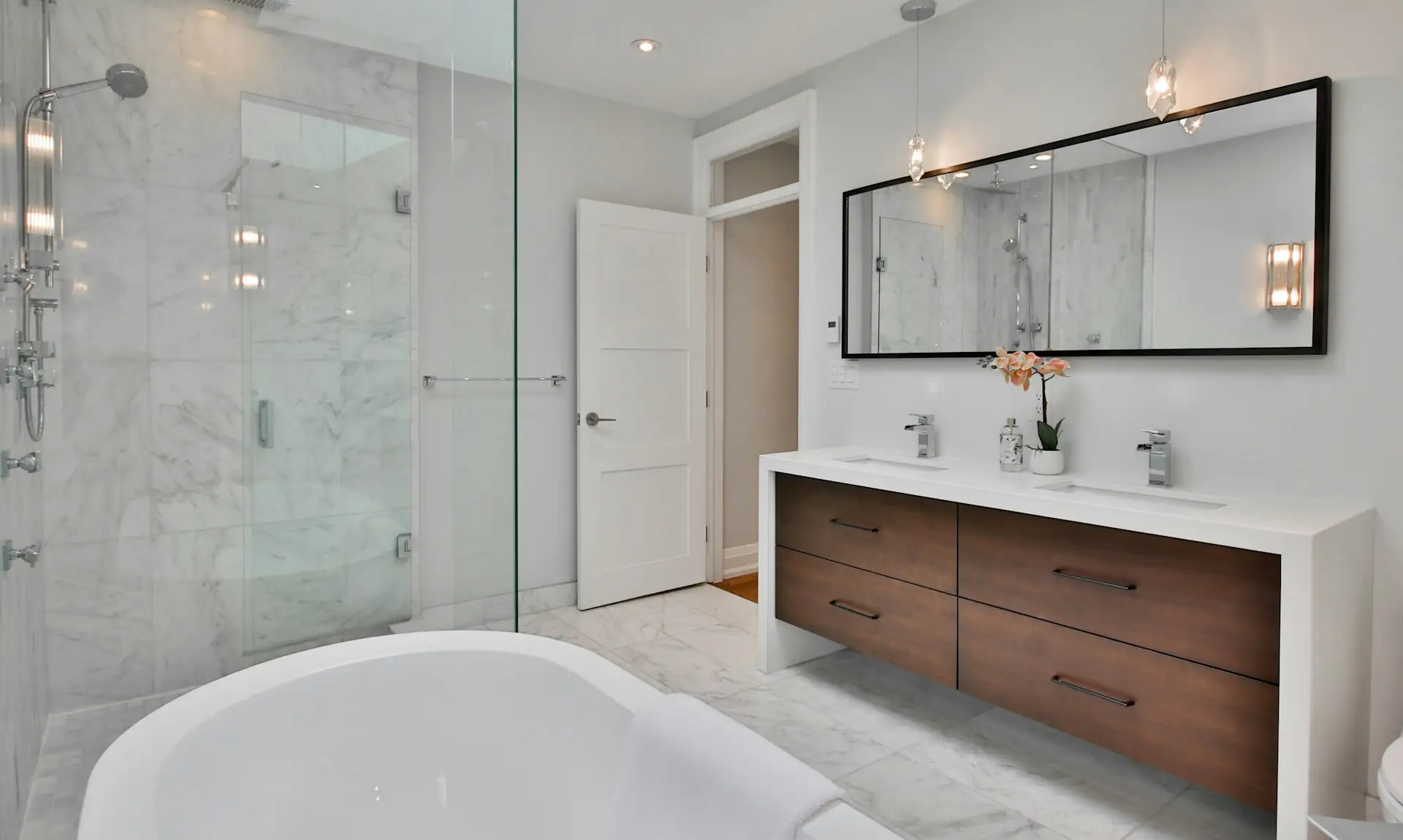 Renovated bathroom with a double vanity and walk-in shower