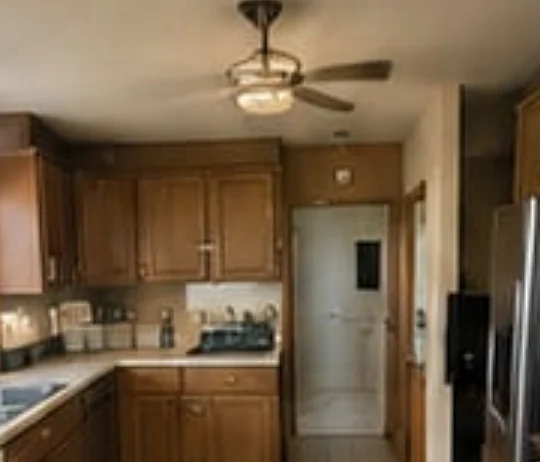 Kitchen before: dated oak, closed layout — Broward County